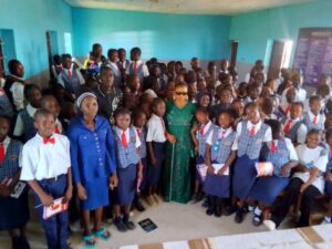 In this photo, there are pupils alongsude Daniella, a visually impaired young woman and her mentor who is also visually impaired