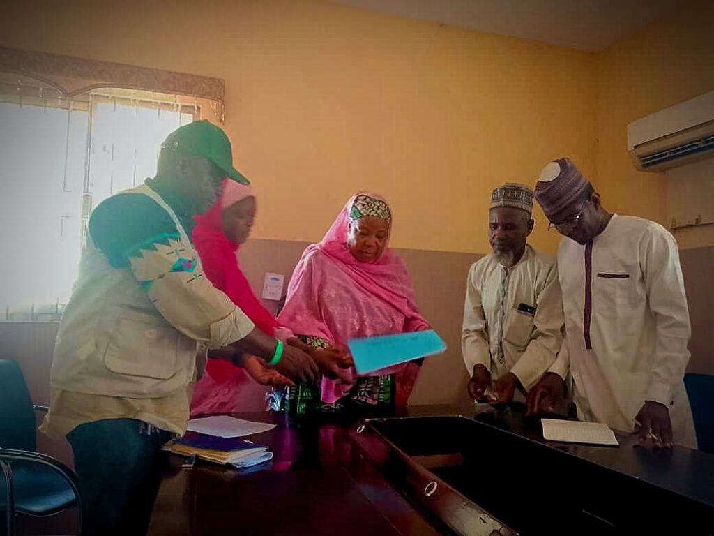 Photo Description: The two images feature participants of an advocacy visit to the Ministry of Humanitarian Affairs in Sokoto State, including the Honourable Commissioner, Hajia Asabe Balarabe. The other participants are members of the State Chapter of JONAPWD in Sokoto State